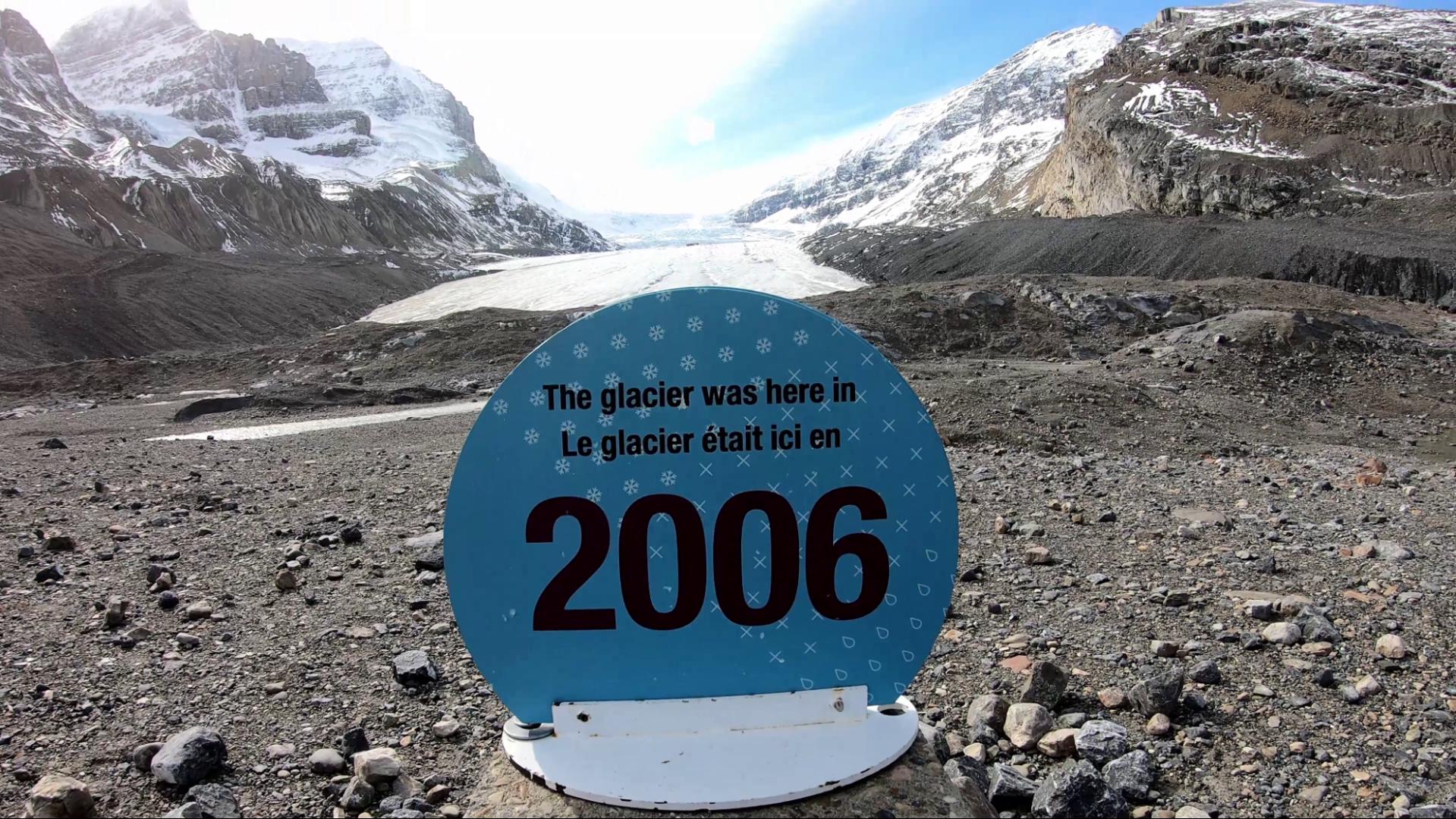 Marker for the point at which the Athabasca Glacier came to in 2006. The Glacier in 2021 appears in the distance. 
