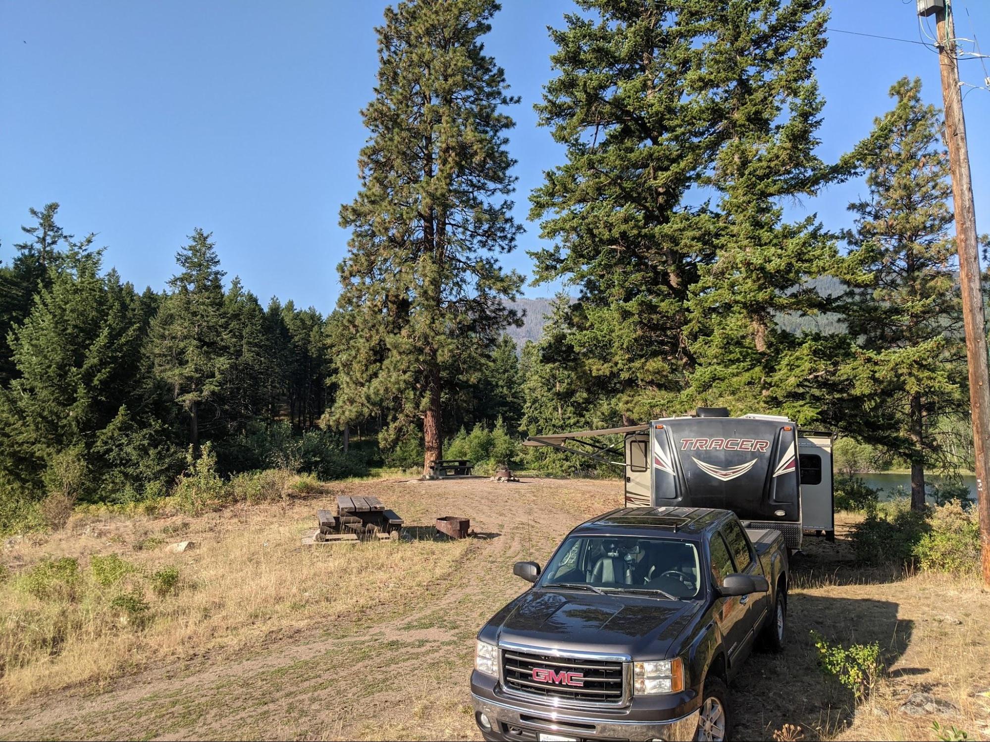 Our travel trailer at the Burnell Rec Site near Oliver, BC. We had a picnic table, fire pit, and there were outhouses/pit toilets available. Then entire site is user maintained and free to camp. 