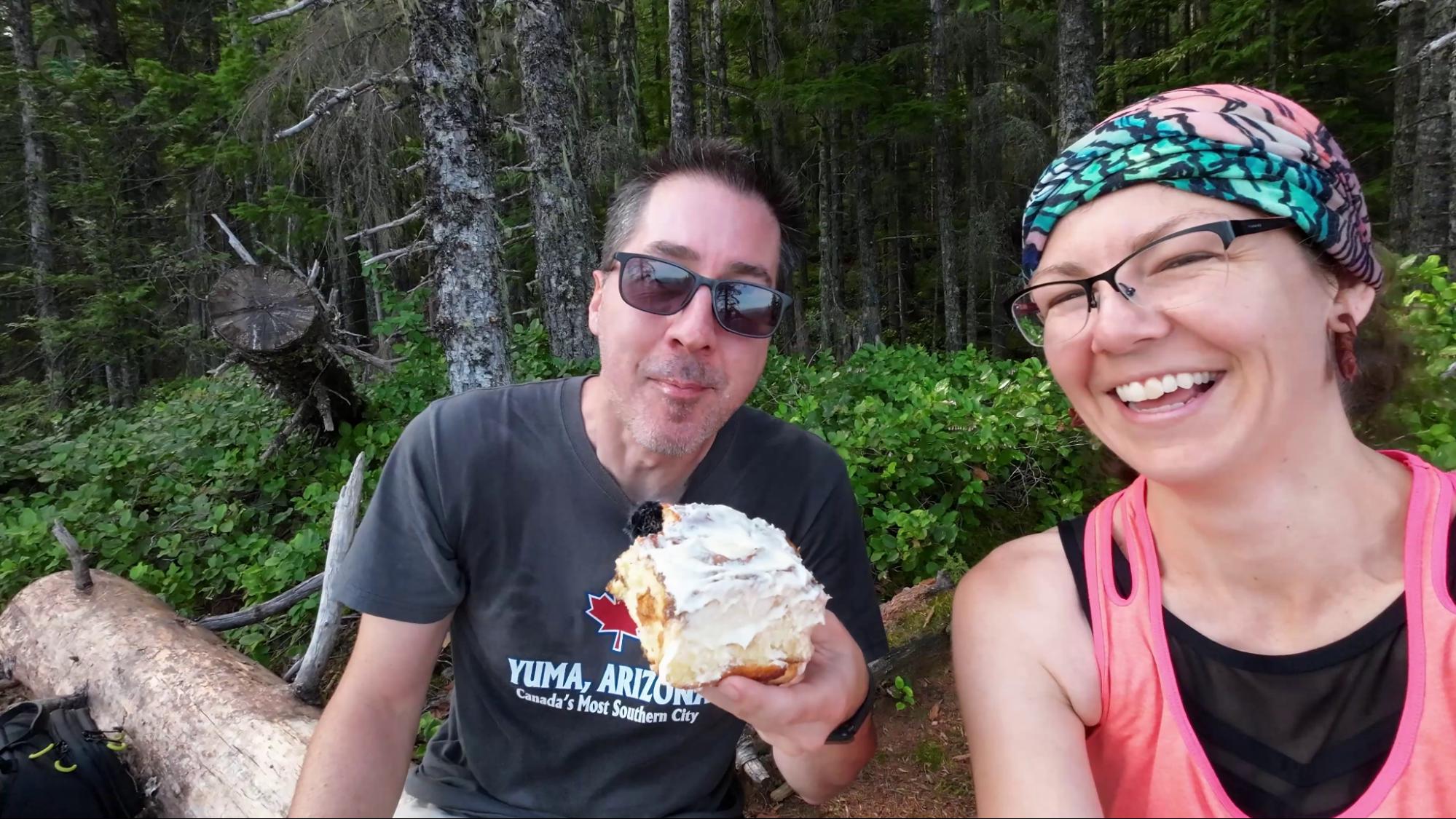 Enjoying a cinnamon bun on a hiking trail on Vancouver Island. 